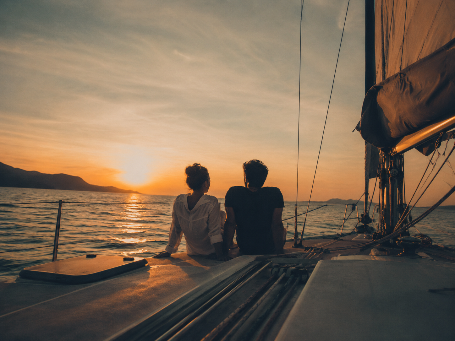 Couple enjoying a sunset sailing charter
